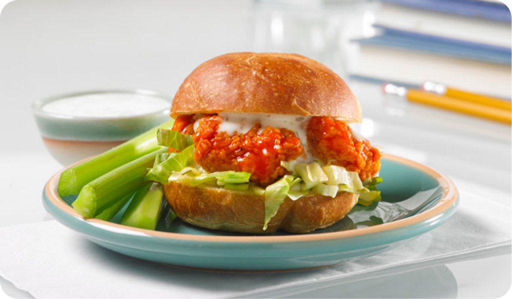 buffalo chicken sandwich with ranch dressing and celery on the side back to school background